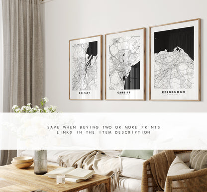 a living room with three framed maps on the wall