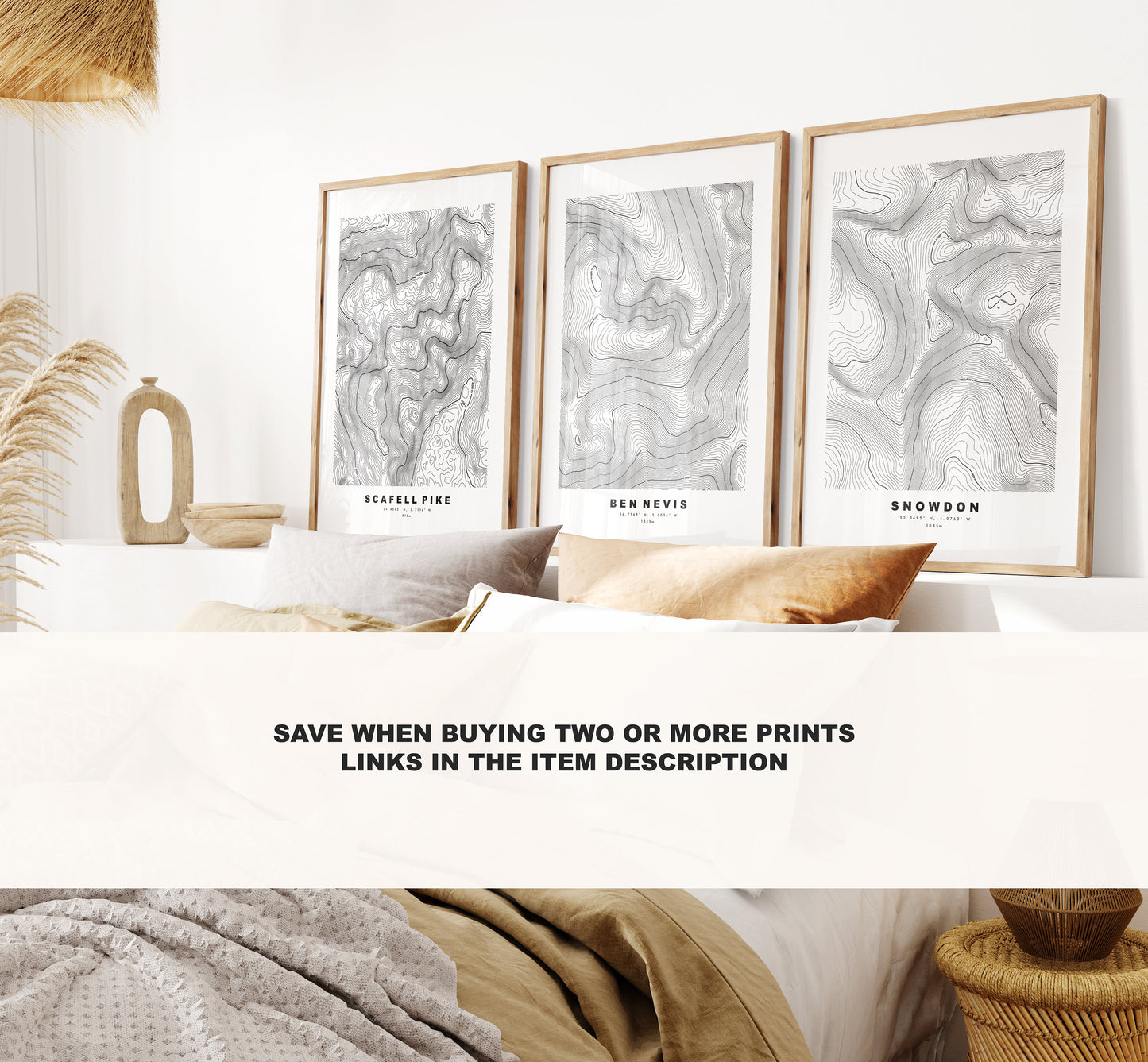 a bed with a white comforter and two pictures on the wall above it